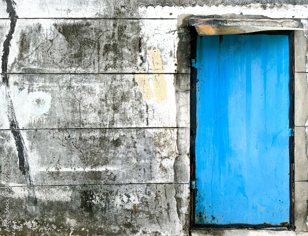 Blue door on old grunge concrete wall background Blue door on old grunge concrete wall background
