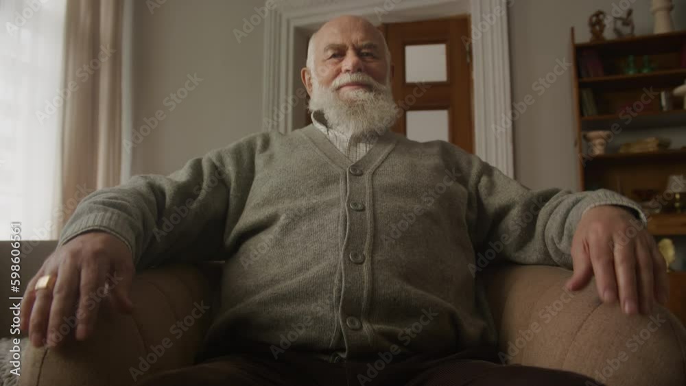 Old Man Sitting Down in Chair and looking at camera Old Man Sitting Down in Chair and looking at camera