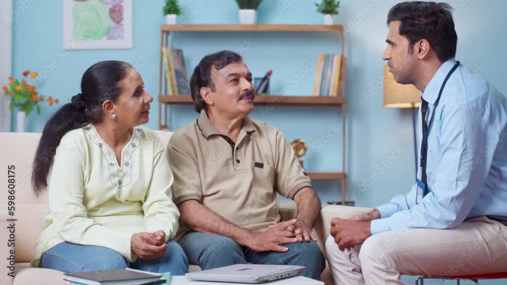 Professional Indian banker explaining about insurance policy to senior couple at home - concept of financial advisor, business expert and