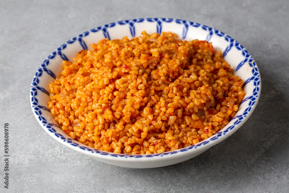 Traditional turkish bulgur pilaf with tomato sause in plate (Turkish name; meyhane pilavi or domatesli bulgur pilavi) Traditional turkish bulgur pilaf with tomato sause in plate (Turkish name; meyhane pilavi or domatesli bulgur pilavi)