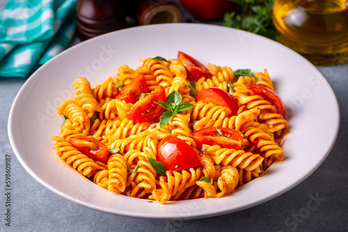 Fusilli pasta, spiral or spirali pasta with tomato sauce - Italian food style (Turkish name; domatesli, domates soslu burgu makarna) photo