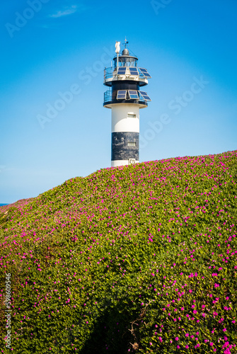 Ribadeo, Galicia, Spain - Abril 2, 2023: Ribadeo lighthouse in Illa Pancha (Pancha Island) photo