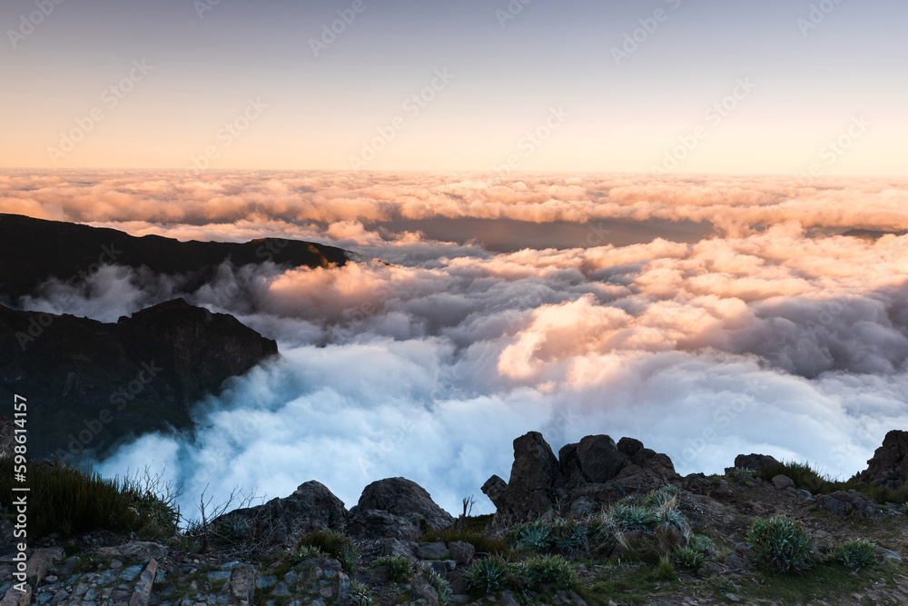 Madeira mountains landscape with peaks above clouds at sunset