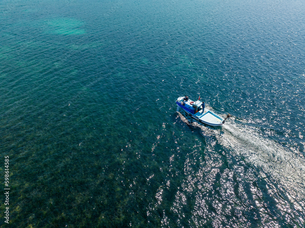 Turkey Pissa bay, fishing boat in the turquoise sea. Turkey Pissa bay, fishing boat in the turquoise sea.