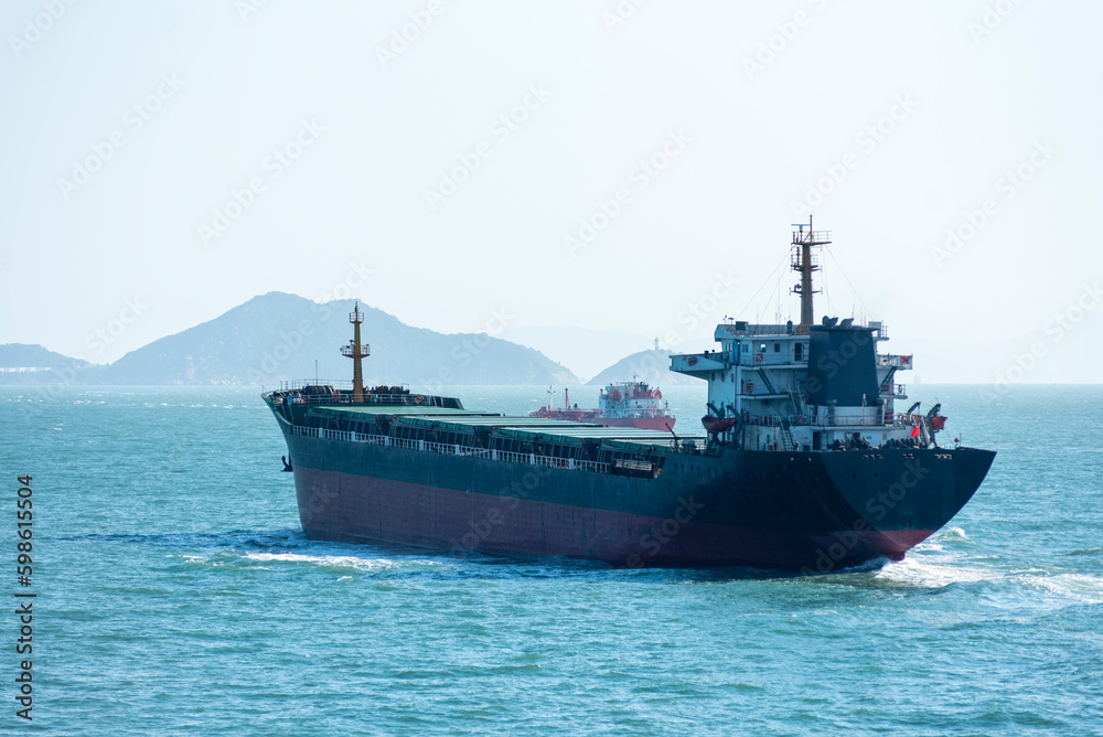 Cargo ship sailing near Chinese sea coast in the vicinity of Macau and Hong Kong. 