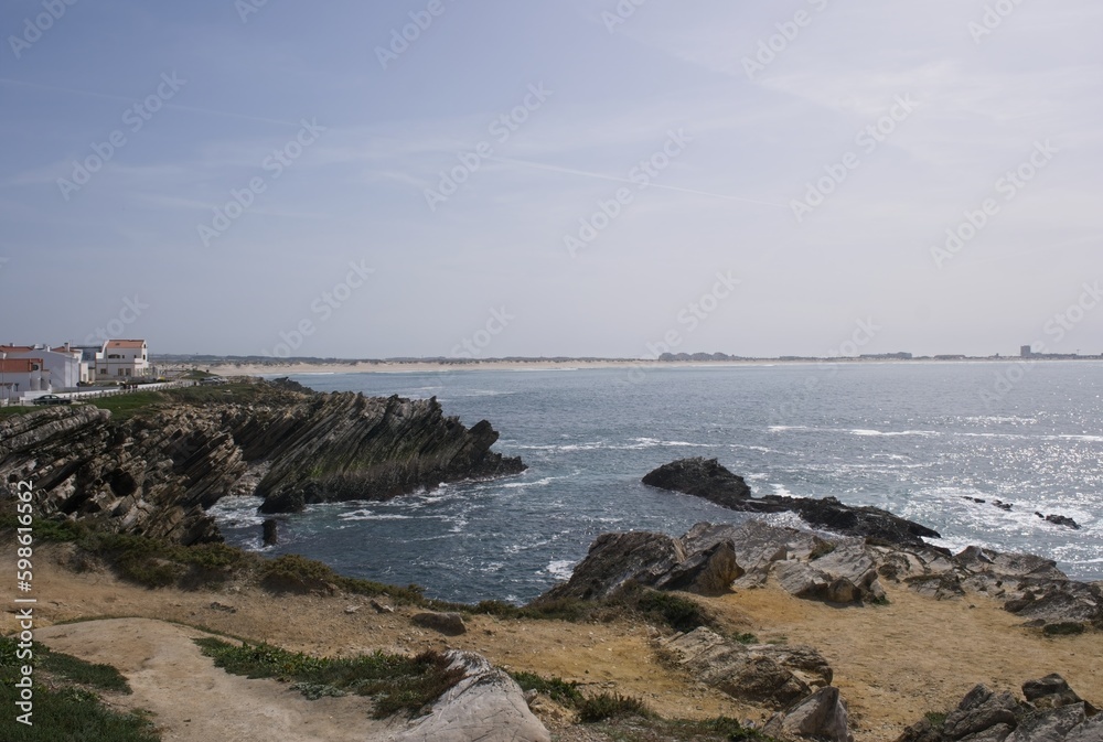 Ferrel, Portugal - March 28, 2023: Wonderful landscapes in Portugal. Scenic coastline in Ferrel. View from the cliff. Rippled sea. Rocky skerries. Sunny spring day. Selective focus