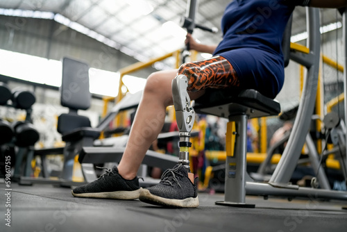 Portrait of disabled athlete woman with prosthetic leg in fitness gym