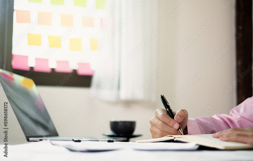The businessman hand sits at their desks and calculates financial graphs showing the results of their investments planning the process of successful business growth The businessman hand sits at their desks and calculates financial graphs showing the results of their investments planning the process of successful business growth
