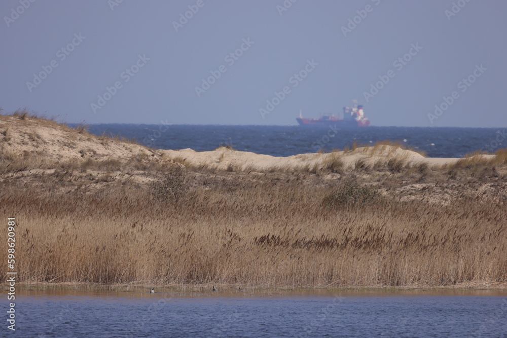Ship at sea with horizon with wild natural terrain Ship at sea with horizon with wild natural terrain