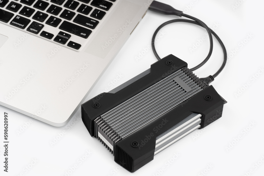External USB hard drive isolated on white background. Waterproof protected external hard drive. Hard disk for connecting to a laptop, transferring data between a computer and a hard disk. External USB hard drive isolated on white background. Waterproof protected external hard drive. Hard disk for connecting to a laptop, transferring data between a computer and a hard disk.