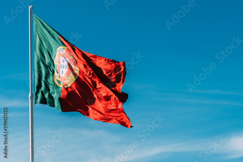 Obraz na plátně Portugal flag isolated on the blue sky waving in the wind