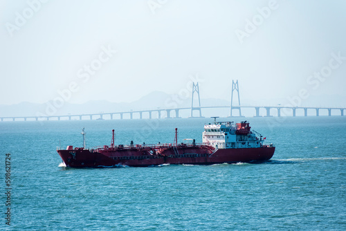 Cargo ship sailing near the Hong Kong Zhuhai Macau  Macao  Bridge  Chinese sea coast.