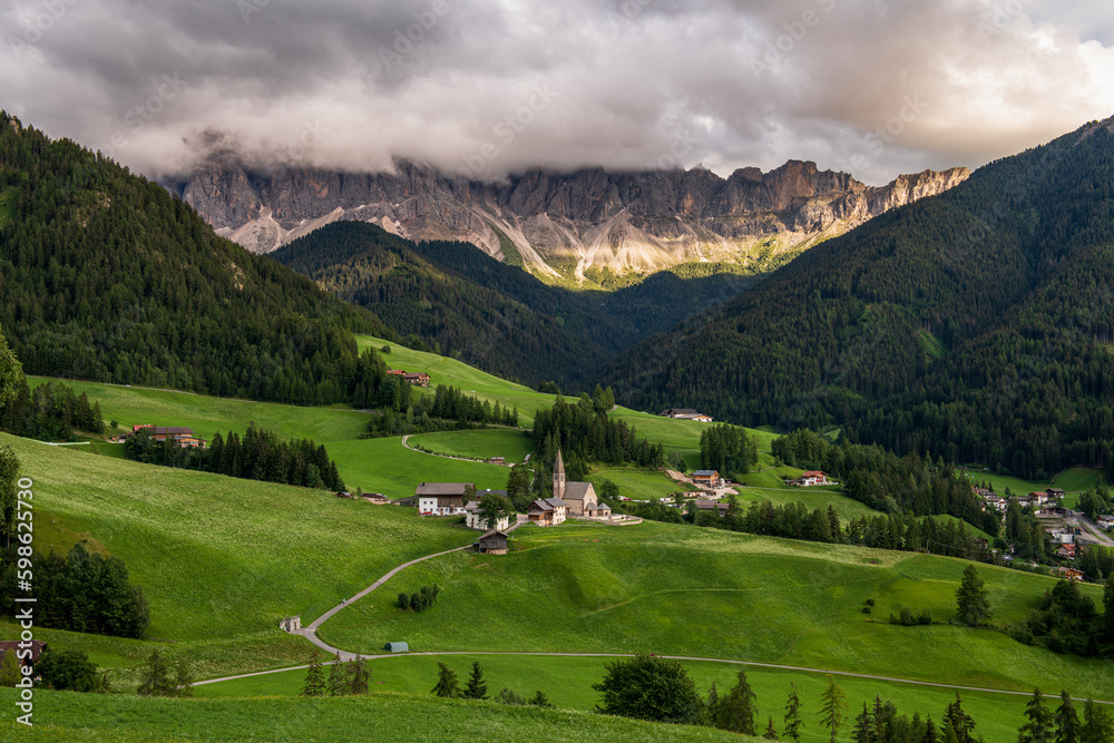 panoramic view of the dolomites in val di funes, the Odle with the village of Santa Maddalena below, Italy