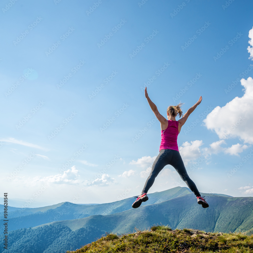 Young woman jumping in the mountains Young woman jumping in the mountains