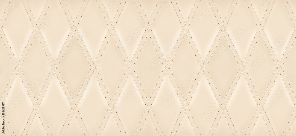 Close-up texture the genuine leather with beige rhombic stitching. Close-up texture the genuine leather with beige rhombic stitching.