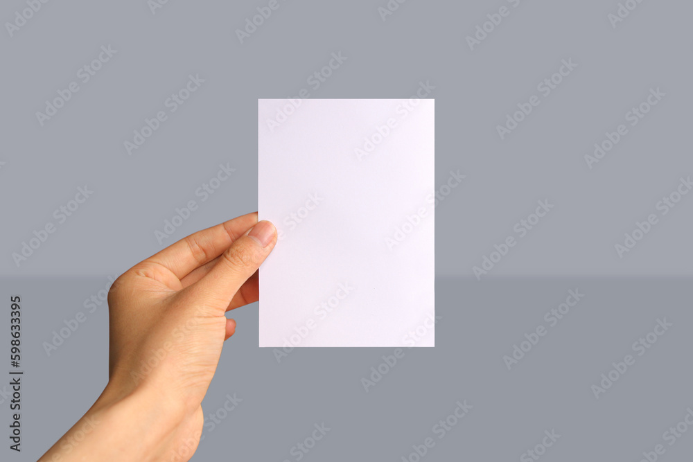 Realistic hand holding A6 paper mockup Portrait A6 international paper Realistic hand holding A6 paper mockup Portrait A6 international paper