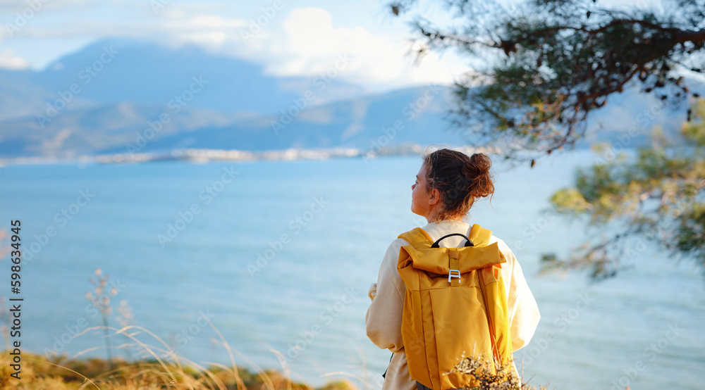 Travel and active lifestyle concept. Happy smiling woman hiking in mountains , Fethie, Turkey. Young female hiker smiling, sport and trekking in autumn or spring nature. Travel and active lifestyle concept. Happy smiling woman hiking in mountains , Fethie, Turkey. Young female hiker smiling, sport and trekking in autumn or spring nature.