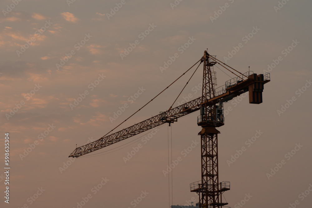 view of a lone tower crane at sunset view of a lone tower crane at sunset