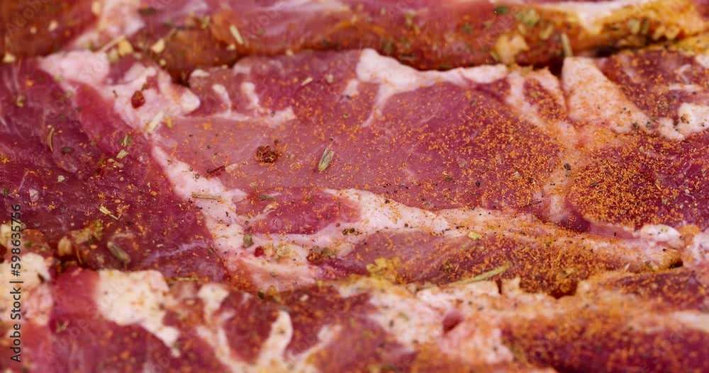 Sprinkle fresh pork meat with a mix of spices for meat , preparing pork neck meat for cooking during camping Sprinkle fresh pork meat with a mix of spices for meat , preparing pork neck meat for cooking during camping