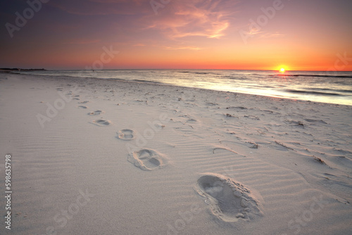 Fototapeta Naklejka Na Ścianę i Meble -  footprints in the sand at Baltic Sea at sunset
