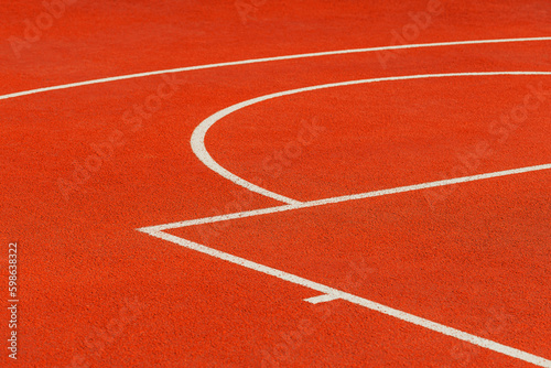 Fototapeta Naklejka Na Ścianę i Meble -  Minimalist abstract background of an orange tartan outdoor basketball court with white lines.