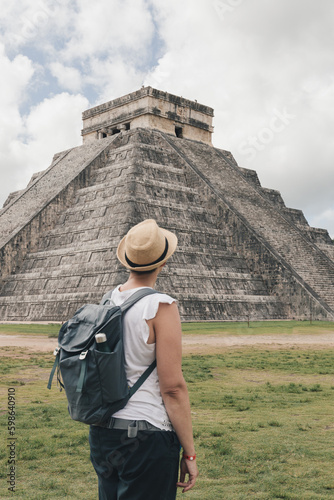 Woman traveler with hat and backpack in Chichen Itza, Yucatan, Mexico