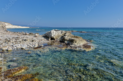 Fototapeta Naklejka Na Ścianę i Meble -  rocks ad reefs at low tide on Alacati coast near Gilikli Beach (Cesme, Izmir province, Turkey)	