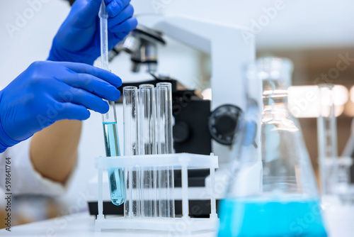 Researcher working in chemical laboratory  doctor in blue gloves  molecular biology investigation.