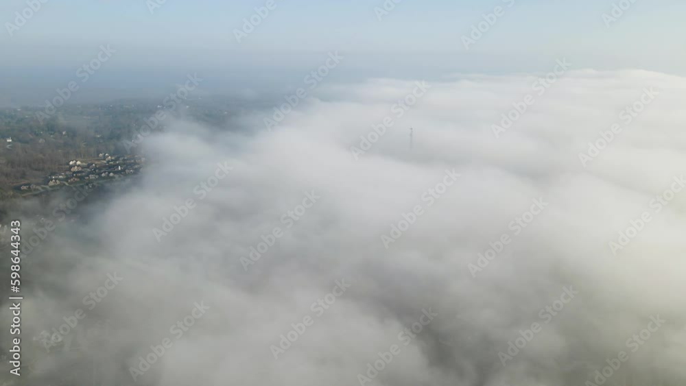 4K Aerial Drone Timelapse above Foggy Clouds against blue sky. Over Residential Area. Reversible Clip.
