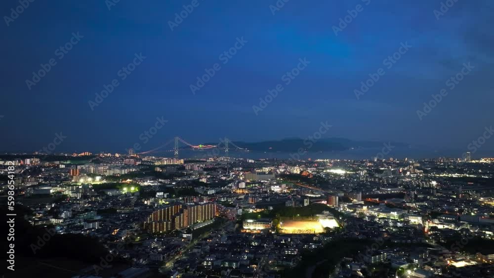 Lights from buildings and baseball field in city by suspension bridge at night Generative AI Lights from buildings and baseball field in city by suspension bridge at night Generative AI