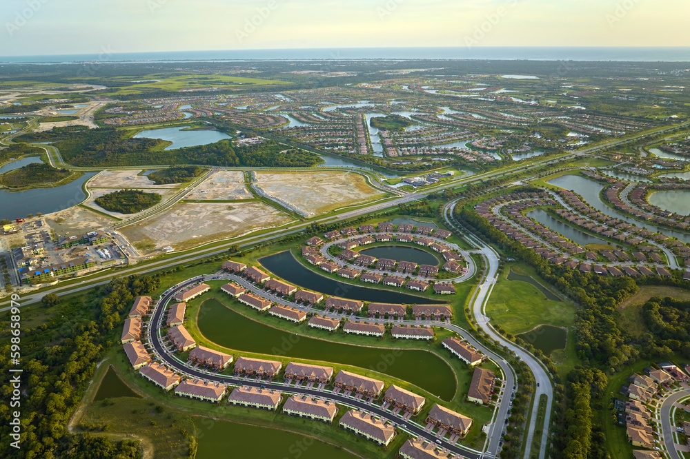 View from above of densely built residential houses under construction in closed living clubs in south Florida. American dream homes as example of real estate development in US suburbs