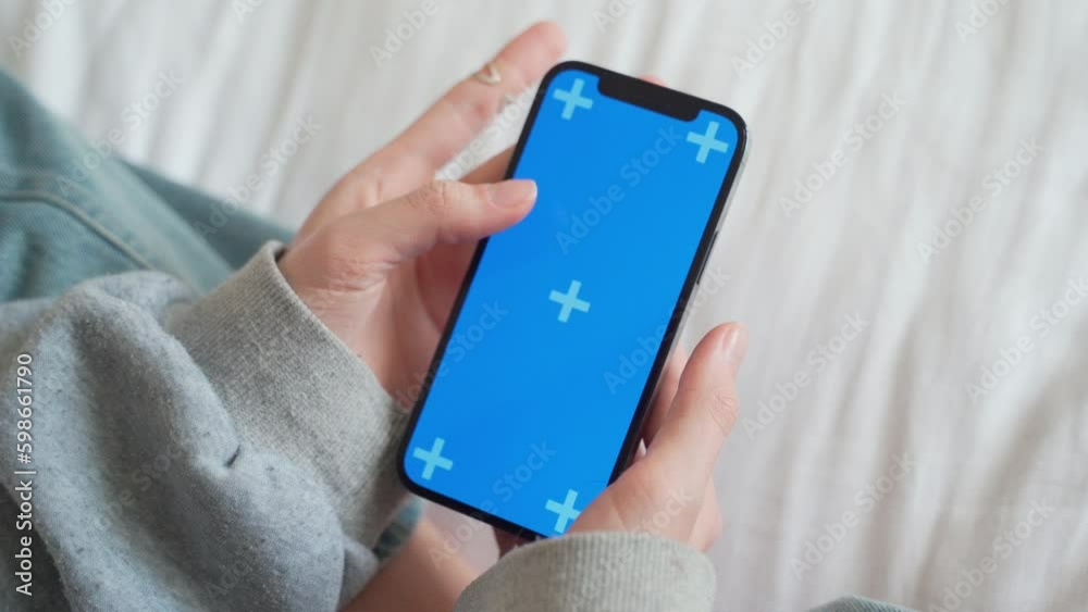 Close up Hand of teenage girl using smartphone with blank chroma key blue screen watching video reel content Generative AI Close up Hand of teenage girl using smartphone with blank chroma key blue screen watching video reel content Generative AI