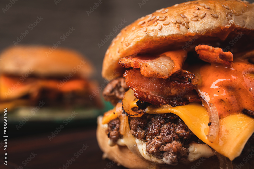 Amazing American traditional smash burger with melted cheddar cheese, bacon, grilled onions and sauce.