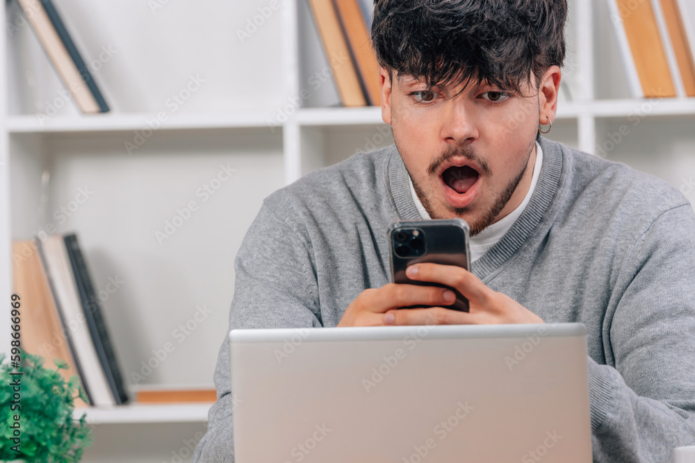 young man in with mobile phone and laptop young man in with mobile phone and laptop