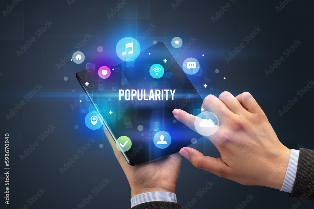 Fototapeta premium Businessman holding a foldable smartphone