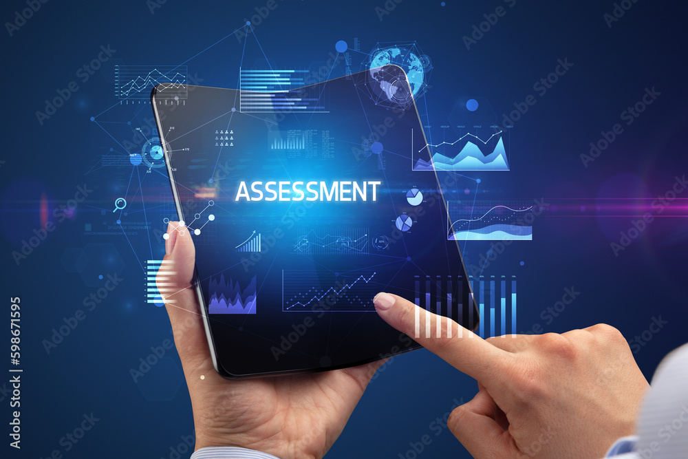 Businessman holding a foldable smartphone, business concept Businessman holding a foldable smartphone, business concept