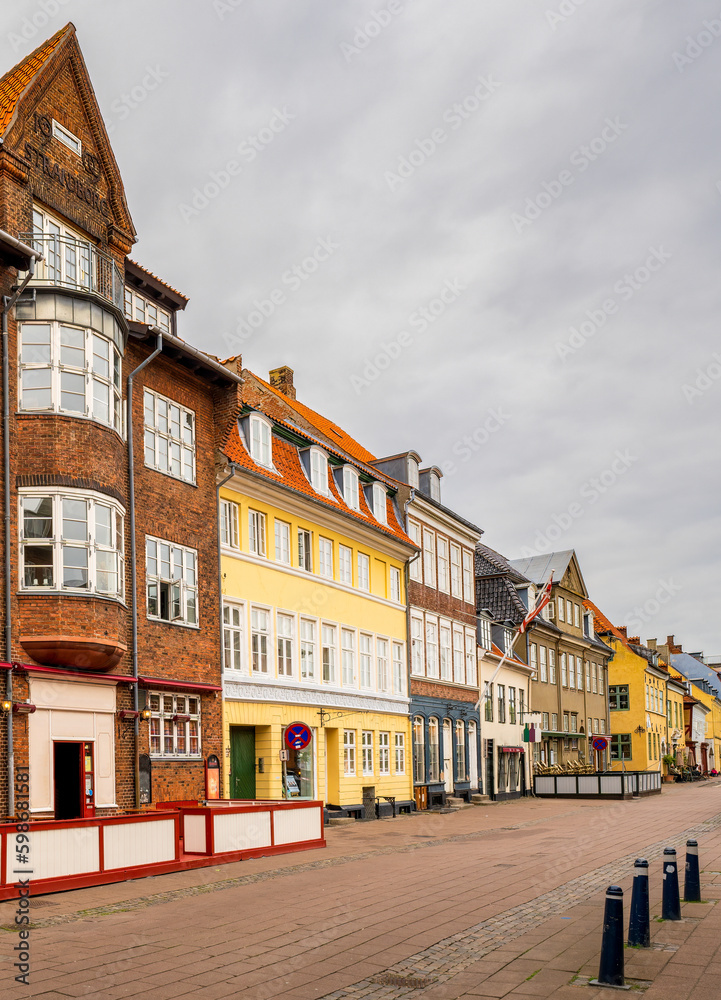 Fototapeta premium Famous old shopping street (Strandgade) with old traditional colourful houses in Helsingor, Denmark.