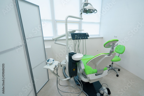 Fototapeta Naklejka Na Ścianę i Meble -  empty modern white and green dentist's office in clinic with computer equipment professional dental chair
