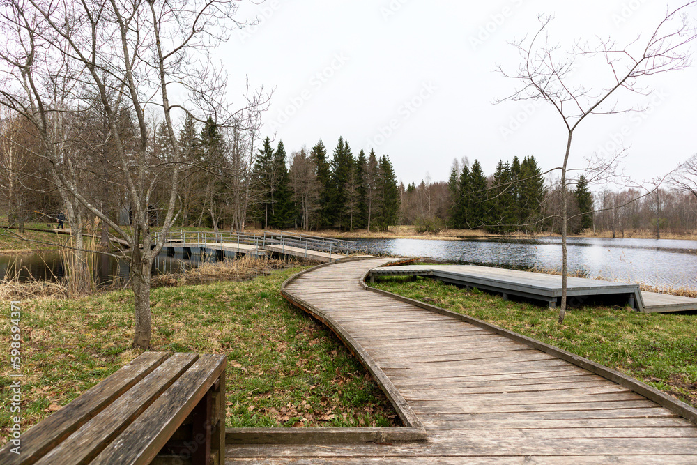 A wooden walkway leads to a lake with a lake in the background.