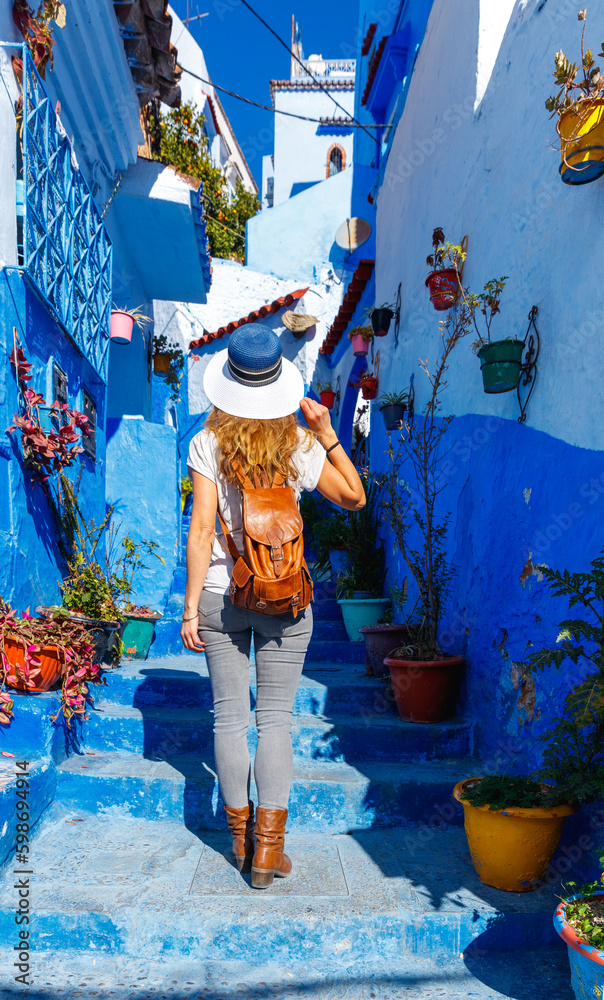 Fototapeta premium Woman tourist walking in Chefchaouen- blue city in Morocco