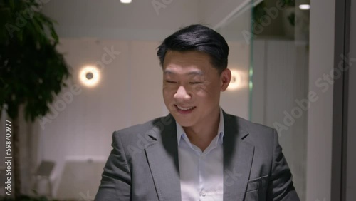 Wallpaper Mural Smiling middle-aged Asian businessman walking in office hallway use digital tablet happy chinese man entrepreneur political leader browsing internet read good news social media walk Generative AI Torontodigital.ca