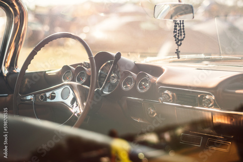Vintage car interior with steering wheel and dashboard, vintage car background © WeźTylkoSpójrz