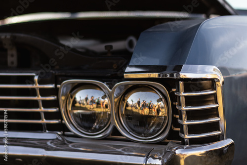 Close-up of the headlight of an old american car