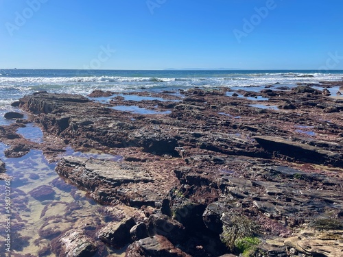 Rocky shoreline with blue sky background in the summer