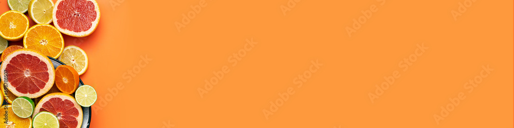 Fresh, Fruity and juicy fruit concept with free text space, web banner. Flat layout with various fresh cut citrus fruits on the left side of the picture on an orange background Fresh, Fruity and juicy fruit concept with free text space, web banner. Flat layout with various fresh cut citrus fruits on the left side of the picture on an orange background