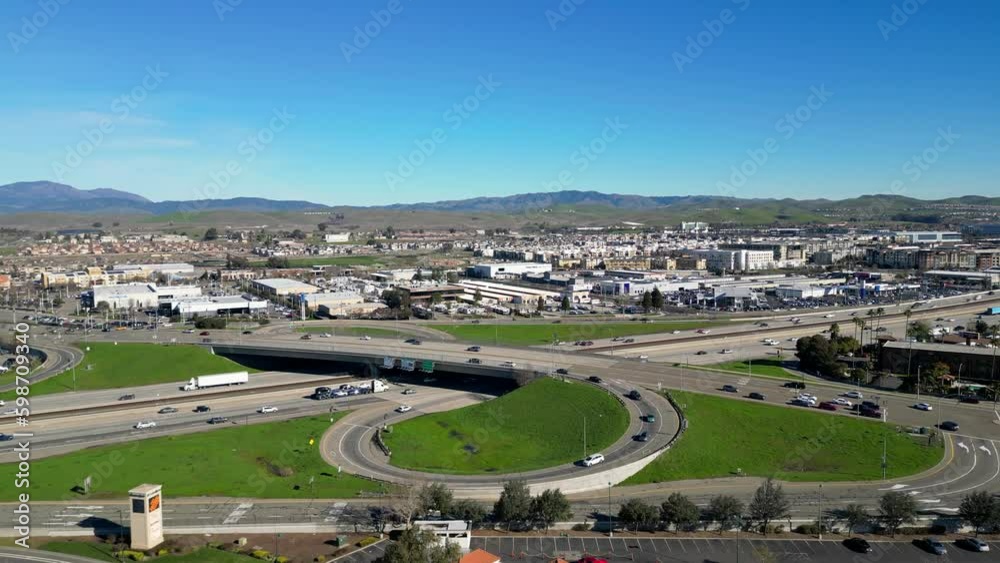 The 4k aerial view of the 580 freeway on and off ramp in Dublin, California captures the busy interchange with its intricate network of roads and traffic flow. The 4k aerial view of the 580 freeway on and off ramp in Dublin, California captures the busy interchange with its intricate network of roads and traffic flow.