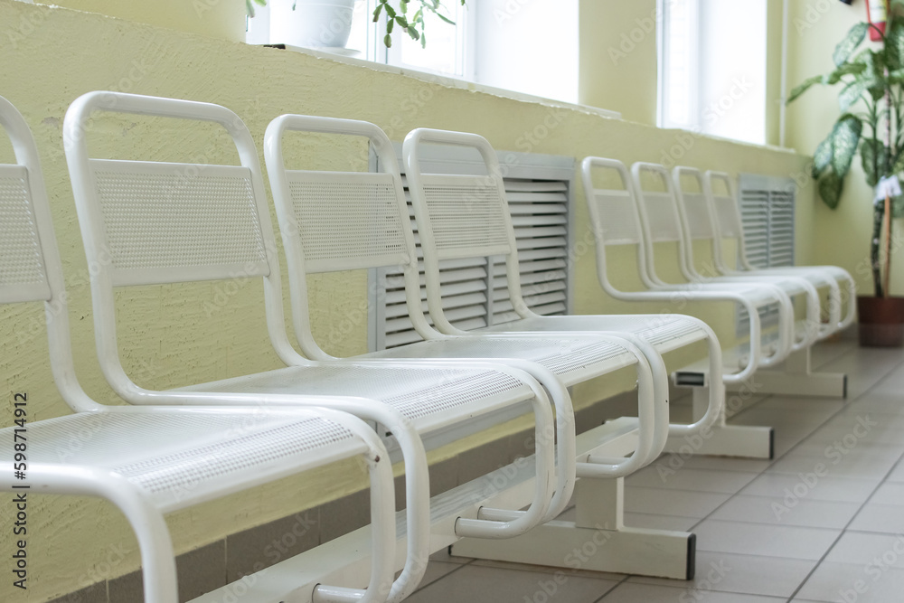 Seat waiting for the doctor in the hospital.Empty and clean waiting area with metallic chairs in clinic. in an corridor there is a waiting room. Lobby room in the hospital. Seat waiting for the doctor in the hospital.Empty and clean waiting area with metallic chairs in clinic. in an corridor there is a waiting room. Lobby room in the hospital.