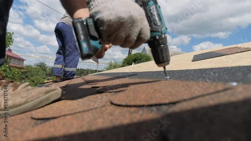Laying of a soft roof. Construction works at height.