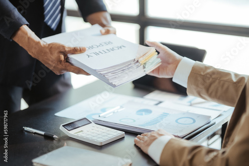 Asian male interviewer and interviewee shaking hands for job interview Businessmen shaking hands in modern office Greeting agreement concept. photo