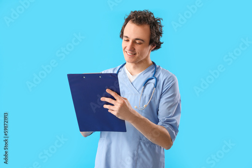 Young doctor writing in cli...